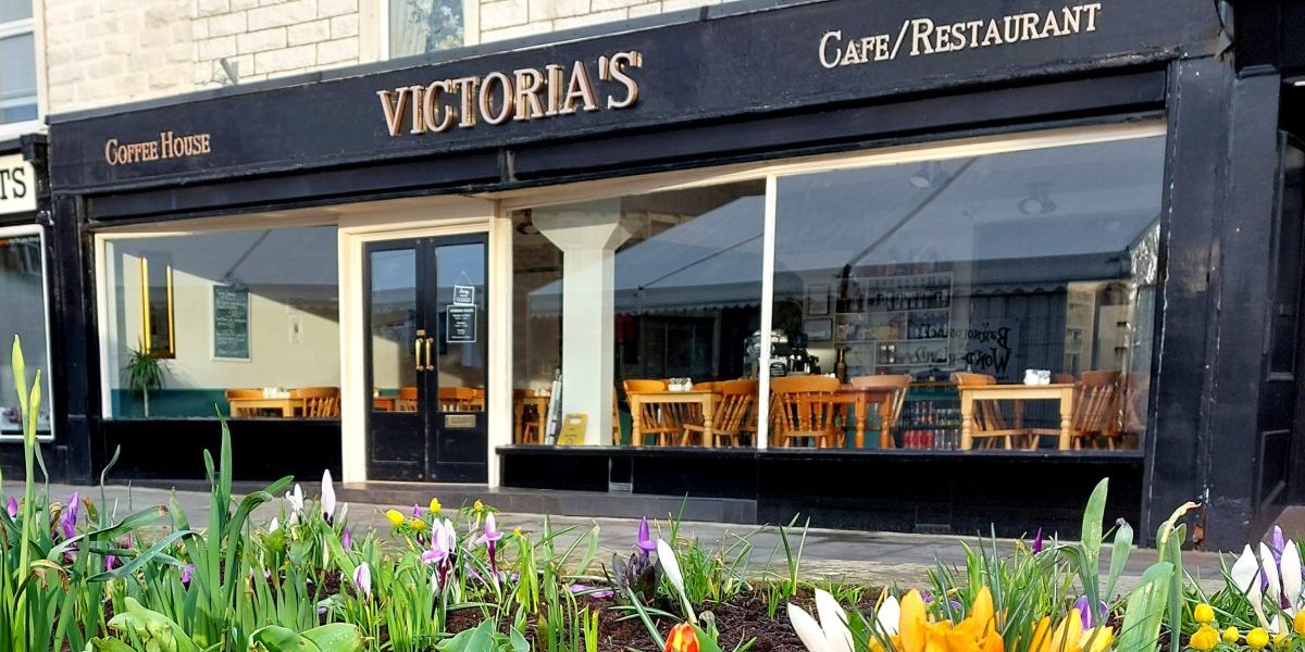 photo of Victorias of Barnoldswick frontage with crocus flowers landscape